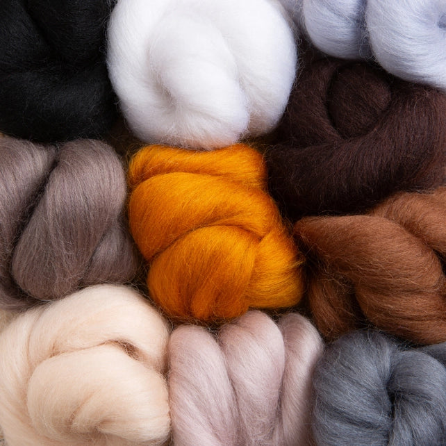 Close up of the roving bundles in white, black, grey, beige, browns and orange.